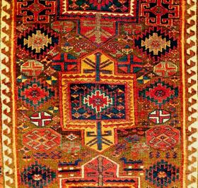   An outstanding Kurdish Sauj Bulagh rug, 19c, with superb dyes, inclding emerald green and pale aubergine, glistening wool and a wide range of design elements. The bottom narrow guard stripe has since been expertly restored. Otherwise all original and intact. The nut brown ground has oxidized to leave the motifs in high relief with satisfying scuptural effect.