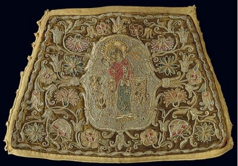 Gold-thread embroidered cuff with a depiction of the Virgin surrounded by vegetation and flowers, part of an Annunciation scene. 19th c. H. 0.19 m. (ΓΕ 9404)   image and text copyright Benaki Museum