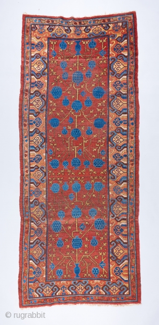Great 18th century Khotan pomegranate long rug. The drawing is dynamic and alive . Some scattered repairs and touch ups but almost all original .        