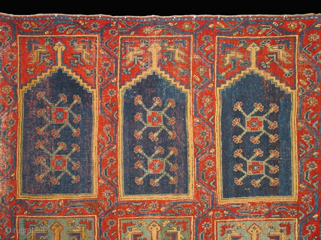 Ushak region carpet fragment of a large mosque prayer carpet with three rows of three prayer niches, late 18th century, 400cm high and 245cm wide. Condition: good overall even pile.
Compared to most  ...