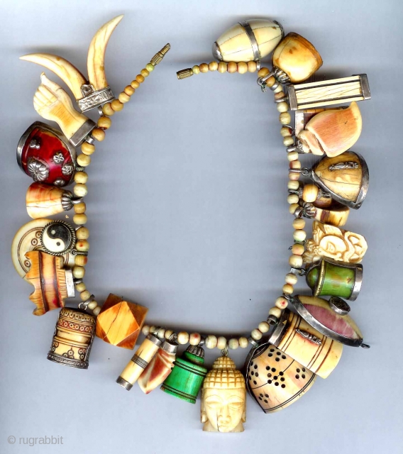 Designed amulet necklace incorporating collected antique charms and game pieces from India, some dating to the 17th and 18th c through early 20th.