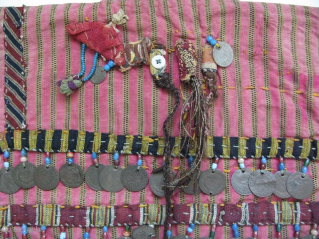 Anatolian Turkmen silk child's ceremonial jacket. Amulets and Talismanic pieces on the back. Ottoman coins from 19th. century. Size: 12" x 25"(30cm x 63cm)