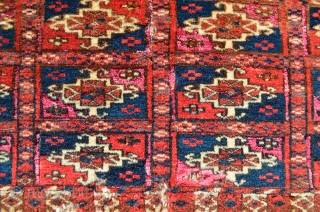 Turkmen. One jumbled up repair and wear and tear. Pink silk highlights in every other gol compartment.  Yellow silk highlights in some of the secondary motifs around the gols that are  ...