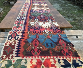 Antique Malatya kilim strip. Size is cm 75x395 or 2'8"x11'2" ca. Age is first quarter 19th century. Colors are simply wonderful: indigo, green, madder, cochineal, aubergine, etc....all fantastic. Some brown must have  ...