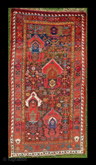 Antique Kurdish rug, Sauj Bulag, 126x238cm, around 1850 with the rare flame design. Fabulous, glowing colours on a brown, corroded field, some spots of cornflower blue silk.      