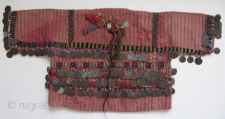Anatolian Turkmen silk child's ceremonial jacket. Amulets and Talismanic pieces on the back. Ottoman coins from 19th. century. Size: 12" x 25"(30cm x 63cm)