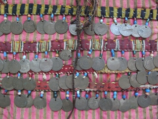 Anatolian Turkmen silk child's ceremonial jacket. Amulets and Talismanic pieces on the back. Ottoman coins from 19th. century. Size: 12" x 25"(30cm x 63cm)