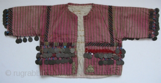 Anatolian Turkmen silk child's ceremonial jacket. Amulets and Talismanic pieces on the back. Ottoman coins from 19th. century. Size: 12" x 25"(30cm x 63cm)