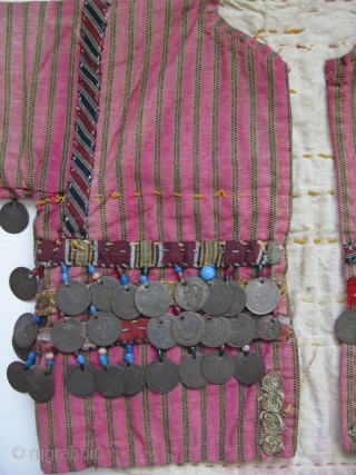 Anatolian Turkmen silk child's ceremonial jacket. Amulets and Talismanic pieces on the back. Ottoman coins from 19th. century. Size: 12" x 25"(30cm x 63cm)