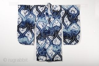 This is a wonderful Japanese children's yukata, or cotton kimono, with a bold
shibori dyed pattern of undulating lines and flowers. This dyed
pattern was created using multiple techniques, including ori-nui
(folded and stitched) and  ...