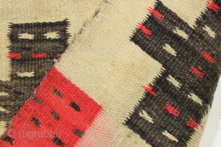 Antique Navajo weaving with intriguing design. So called "pound" rug or blanket. Crude, thick weave. Natural wool colors and characteristic red. Dirty and with end damage as shown. Late 19th c. 4'2" ...