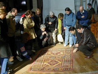 Examining a Ghirlandaio type rug in the Black Church, Brasov 2002