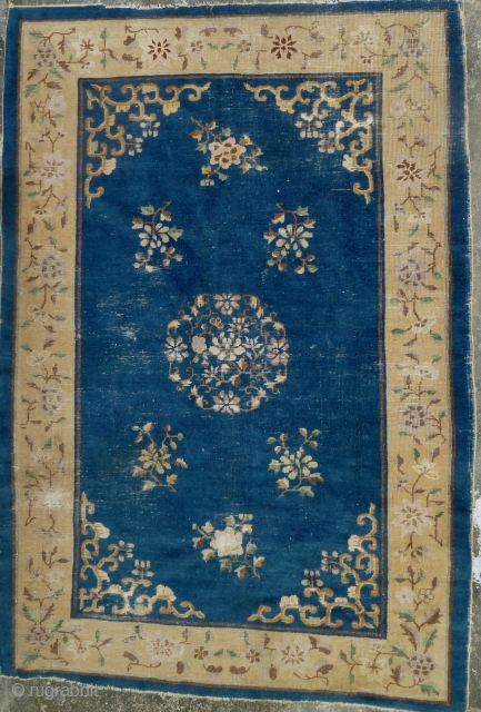 China Rug: Beijing/Tianjin carpet circa 1910, with floral design throughout. Worn down to the warp and weft in many places but no big tears and the selvedge seems to be complete and  ...