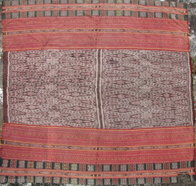 Timor Sarong: Semi antique Timorese womam’s skirt made from all natural dyes and handspun cotton circa 1950/1960. Both top and bottom have “buna” woven panels. There is 7cm x 4cm piece missing  ...