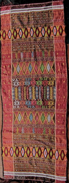 



Indonesia, Batak Ulos: Colorful hand woven beaded shoulder cloth from the Batak people, Sumatra. This piece is quiet lively and complicated with gold treads, and large “Rasta” colored diamond patterned warp embroidered  ...