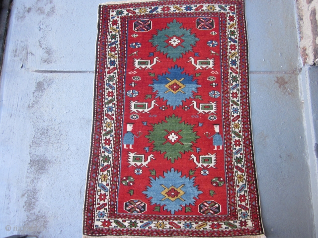 Perpedil Shirvan Rug circa 1920 , 3.1 x 2
 This rare miniature rug exudes cuteness.The two figures holding flowers,the six ivory birds characteristic of larger Perpedil rugs,the alternating light blue and kelly  ...