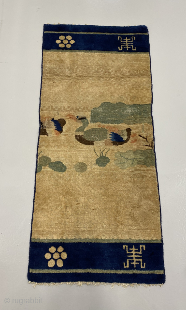 Funky Chinese fragment with a goose swimming behind the posterior of another one. Size 121 x 54 cm. Very archaic feel, both in drawing and wool. 18th century? Older? Ningxia or Gansu?  ...