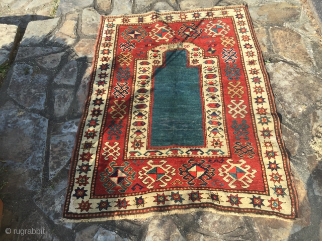 Sweet little kazak prayer rug dated 1902 or 3. Good condition. Simple and effective design. Good weave. 58 by 38 inches. Small area of repile on bottom left of the rug.  