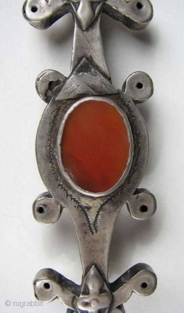 Turkmen Bead,  Silver with Carnelian, 1” x 3.5” Late 19th/Early 20th Century
There are silver triangles on both sides which appear to be old repairs.        