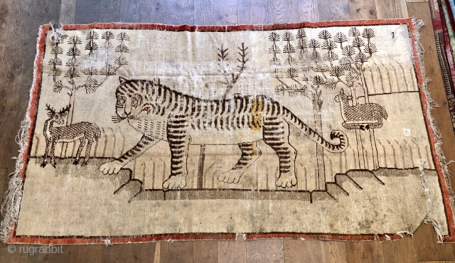 Lovely antique Khotan tiger late 19 c size 95 x 53 inches
Handspun cotton foundations unusually the red outer border seems  to be natural dyes so could be a bit earlier
Could use  ...