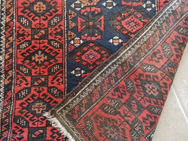 Antique Mina-Khani Baluch rug with character. A good 100-year-old piece with all natural dyes and deep corrosion of black wool rendering good relief and thus a sculptured effect to the field and  ...