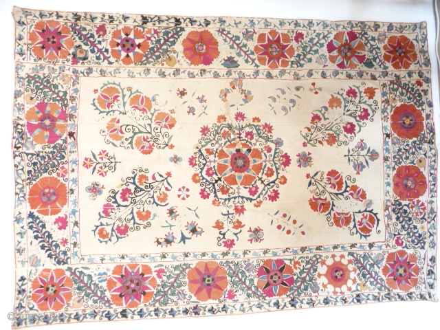 Lovely old suzani , 19th cent. good colours with a powerful border , unlined with some of the embroidery rubbed and repairable damaged area in the centre, cotton ground strong, not pristine  ...