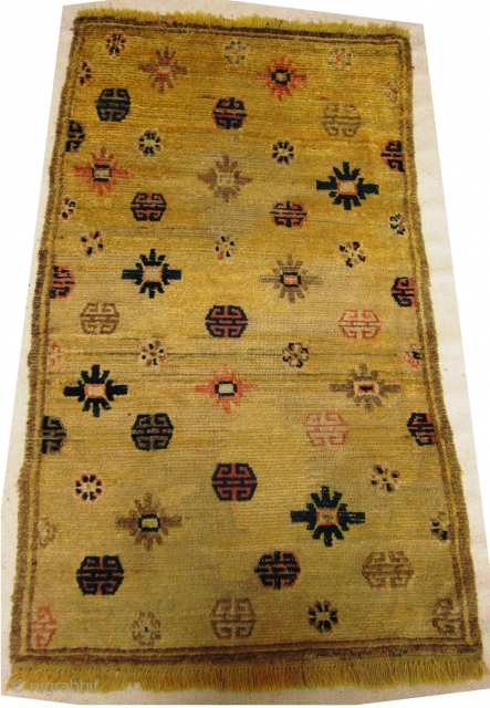 Mid 19th century Tibetan Prayer rug in Ningxia yellow, size 84cm x 141cm, Fringes on both ends are not original there are three small repairs in the field. Pile wear to centre.  ...