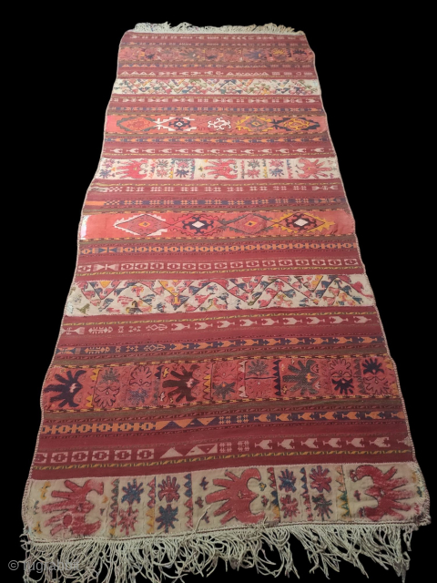 Uzbek Kilim, Central Asia, 1920s, 317 x 130 cm, wool, wool embroidery, narrow bands of plain weave over-embroidered with Central Asian motifs, in good condition, scattered loss of embroidery.    