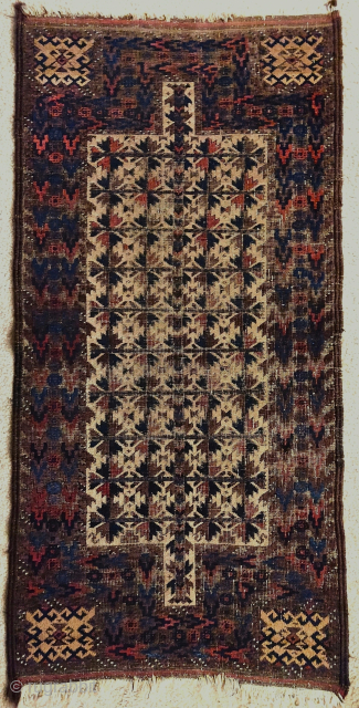 Enigmatic double niched Baluch rug. This is the only example of the format that I have seen that is asymmetrically knotted. There are two distinct colors of camel used, one in the  ...