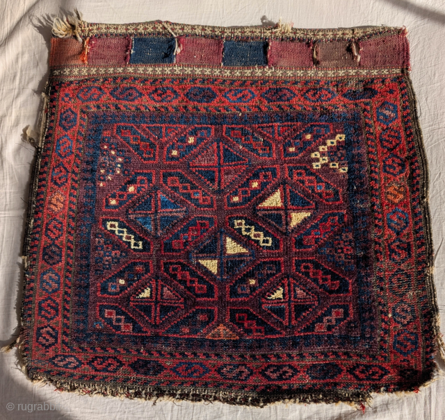 Aubergine ground Baluch bag face. Two purples, two blues, cotton white pile. All good colors with super wool. Former James Douglas Collection.           