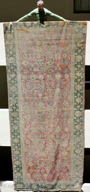 Indo-Isfahan Carpet, second half of the 17th century. Worn and with several generations of scattered repairs but complete. Apx. 8'x18'             