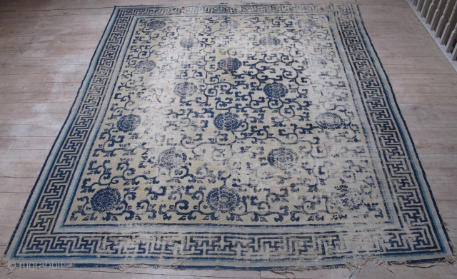 Classic Chinese Ningxia Carpet with vine-scroll and peonies field. Likely Kangxi period, large, smashed, with rips, tears, and several generations of repiling. Still majestic. About 8'x10'       