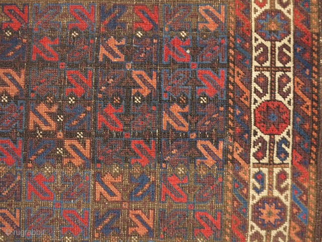 small symmetrically knotted Baluch rug. The field design is composed of a repeat made up from the tendrils of harshang blossoms (blossoms excluded) of the type more typically found in the borders  ...