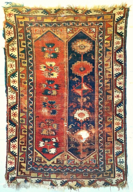 Makri rug with double cartouche field.                           