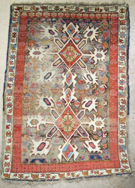 Starburst Caucasian Zeichur rug with a dark corroded ground, very colorful with a sculptural effect.                  