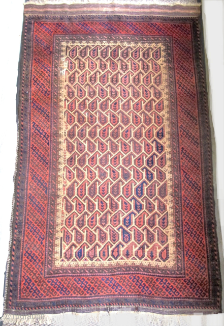 Very graphic camel ground Baluch rug with unusual geometric botehs arranged in a subtle but sophisticated repeat, creating diagonal negative space that works very well with the diagonal latch-hook striped border. The  ...