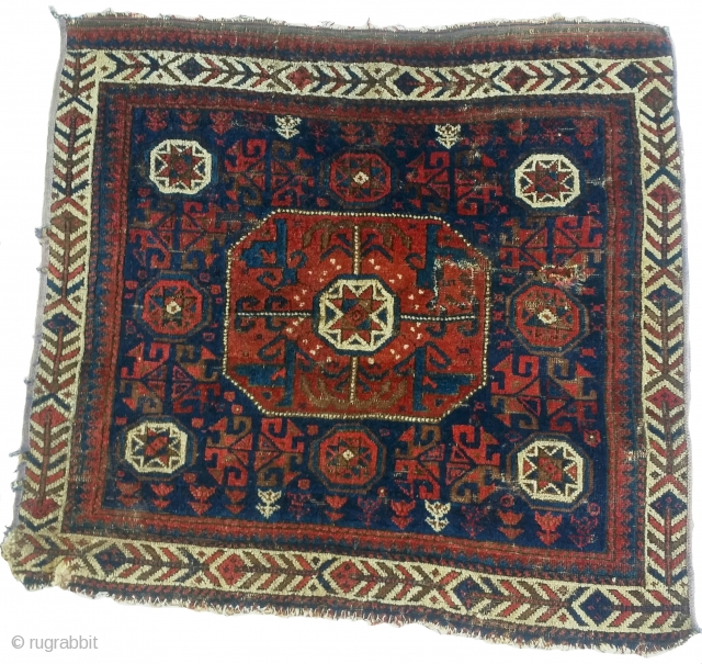 Baluch octagon star bag, not just more of the same. An older example with individuating features and an idiosyncratic cinnamon hue to the reds. Several blues. Large and very readable with a  ...