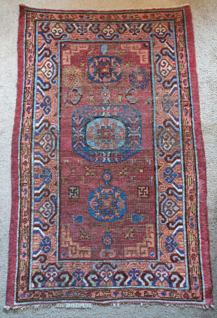 Khotan rug, smaller size measuring 3'6"x5'7". Classic central medallion design with a fantastic border. Areas of conservative restoration.               