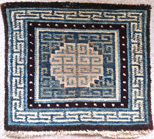 19th century Tibetan square, several indigo blues and intriguing integration of the corner-pieces with the central medallion, 61x56cm               