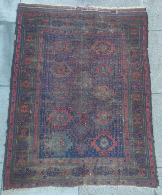 Baluch main carpet with a 'harshang' variant palmette design. Worn but still regal with excellent blues. Unusual 3 column variant.
             