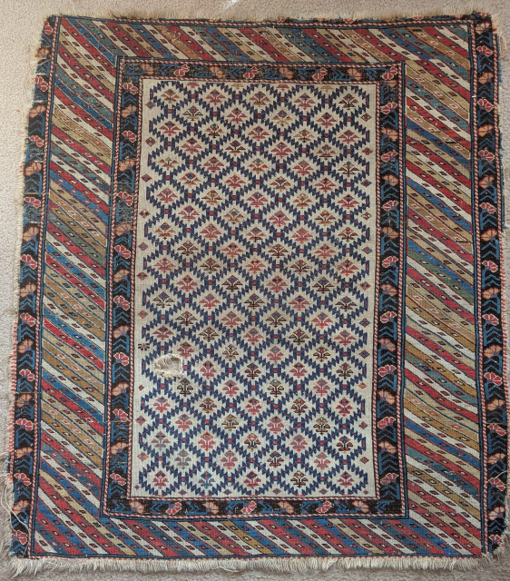 Squarish Caucasian Kuba rug with large diagonally striped border and ivory field with shrubs, loss to sides, Rather charming, 3'5"x4'0"             