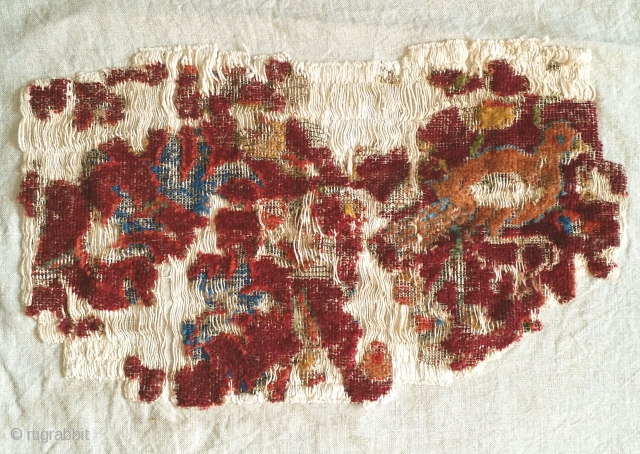 small mounted fragment of a Northeast Persian Khorosan carpet. The bird seen on this piece is reminiscent of those seen on a much larger Northeast Persian 'Portuguese' carpet fragment sold as lot  ...