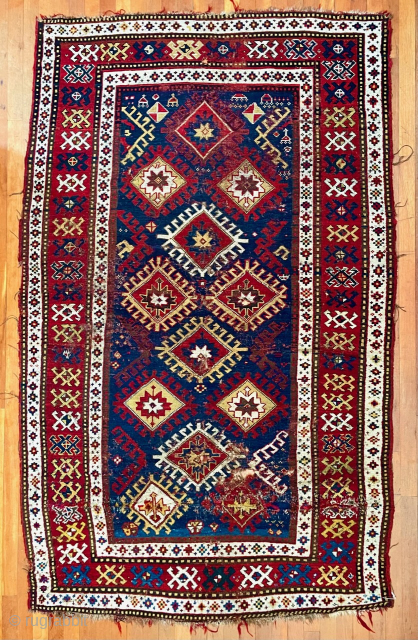 Caucasian Kazak rug, late 19th C.  Generous size--54 inches wide by 86 inches long (4 feet 6 in. x 7 feet 2 in, or 135 cm x 219 cm).  Blue-ground  ...