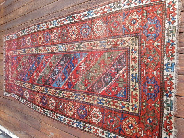 DECORATIVE KAZAK/GENJE CARPET WITH GOOD SIDES AND A BIT OF END LOSS - SIZE IS    4 FT X 9  1/2 FT -   PRICE - $700  