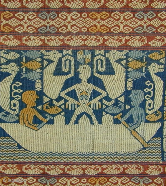 East Sumba Ceremonial Sash. Woven in supplementary-warp technique. Yellow and blue details are painted in after the weaving is completed. 199x57 cm. Mid-20th Century. Background colours are natural indigo and brown derived  ...