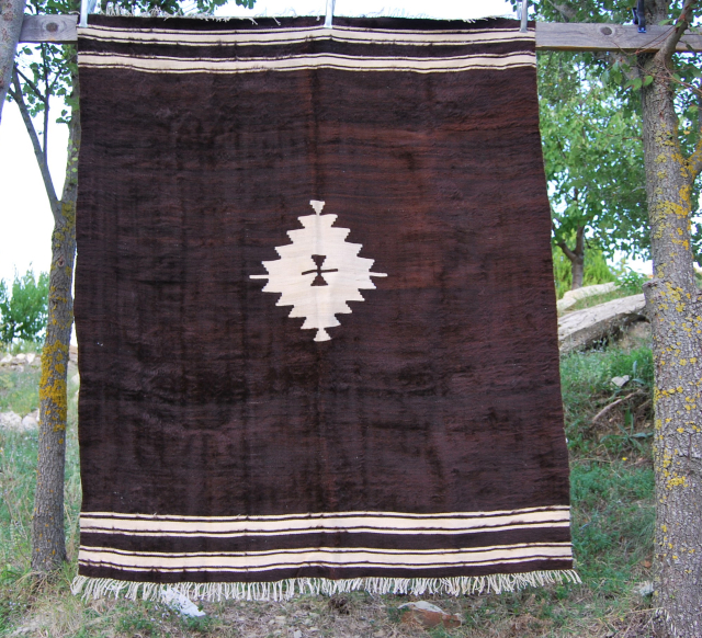 Navajo, USA?....Nooo....Siirt, Turkey!
It's an angora goat hair/wool blanket from Siirt area, in Eastern Anatolia.
First half 20th century. Cm 140x166. In good condition. 

Minimalism in rugs. One of the best Minimalism expressions. 
See  ...