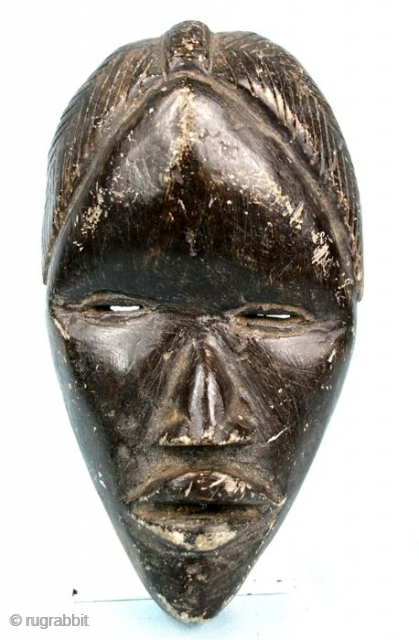 African, stone, carved mask. 
Ivory Coast-Liberia, mask  by the Dan tribal group. 
Second half of the 20th  century. 
Cm 20x12x6,5. Weight 1kg/2pounds ca. 
Great carving quality. 
It looks like a  ...