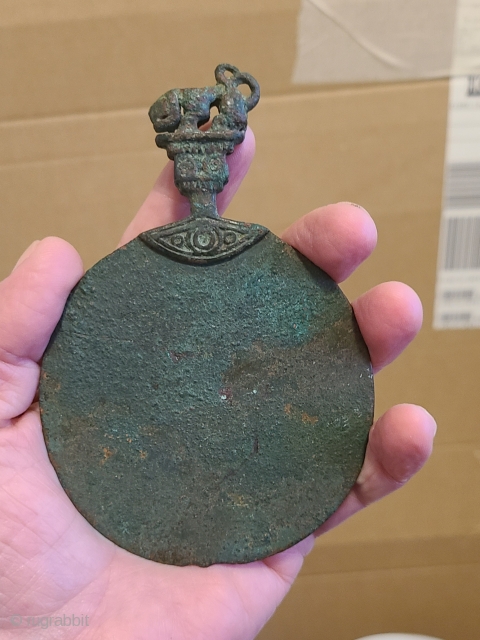 A very rare and good example of a bronze mirror from Central Asia. A tiger sits atop the handle finial. The size is 12.5 cm. from top to bottom. 1500-800 B.C.E.

Contact: Chakra.asianart@gmail.com 