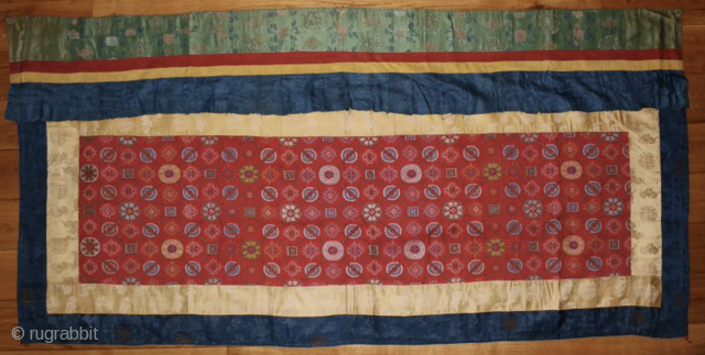 A 19th century Tibetan Silk Temple Banner. Dimensions: 67 x 37 inches (170 x 94 cm.)                 