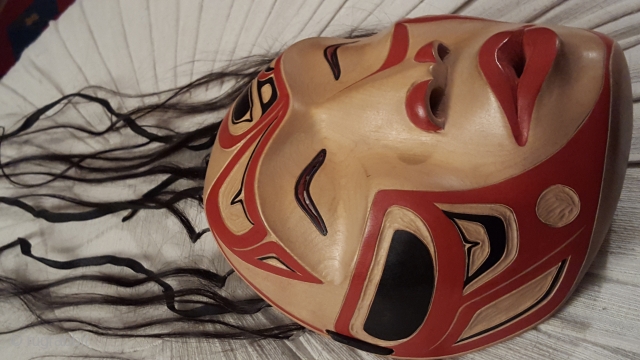 Wonderful NordWestCoast-Indians ( British Columbia/Canada) mask made of wood and original human hair with beautiful symbolic decorations in red and black.
Picture of carver with this mask in the hand ,fixed in the  ...